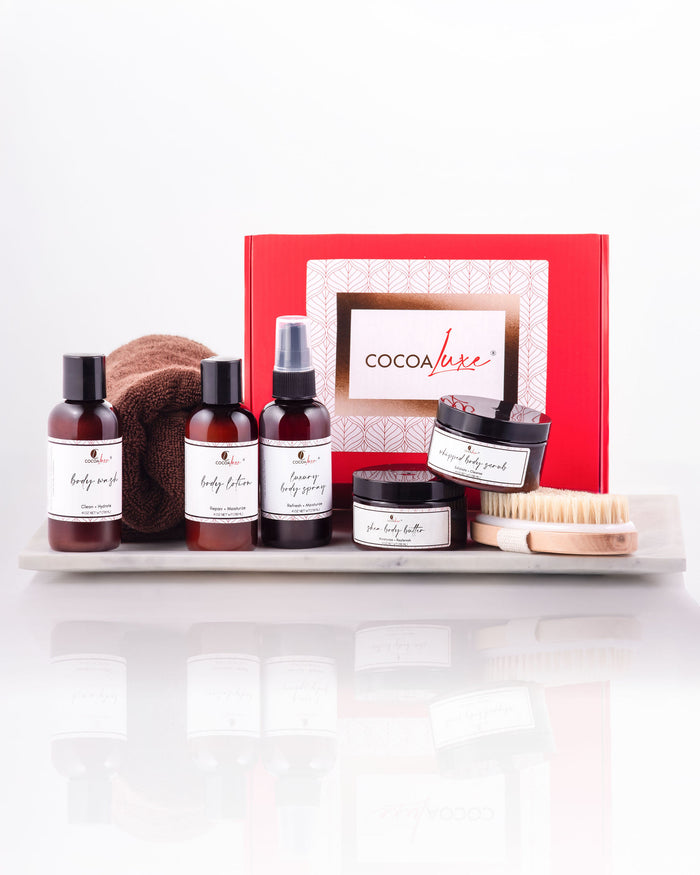 CocoaLuxe bath and body mini gift set with body wash, body lotion, body spray, whipped scrub, and body butter presented in a CocoaLuxe branded gift box.