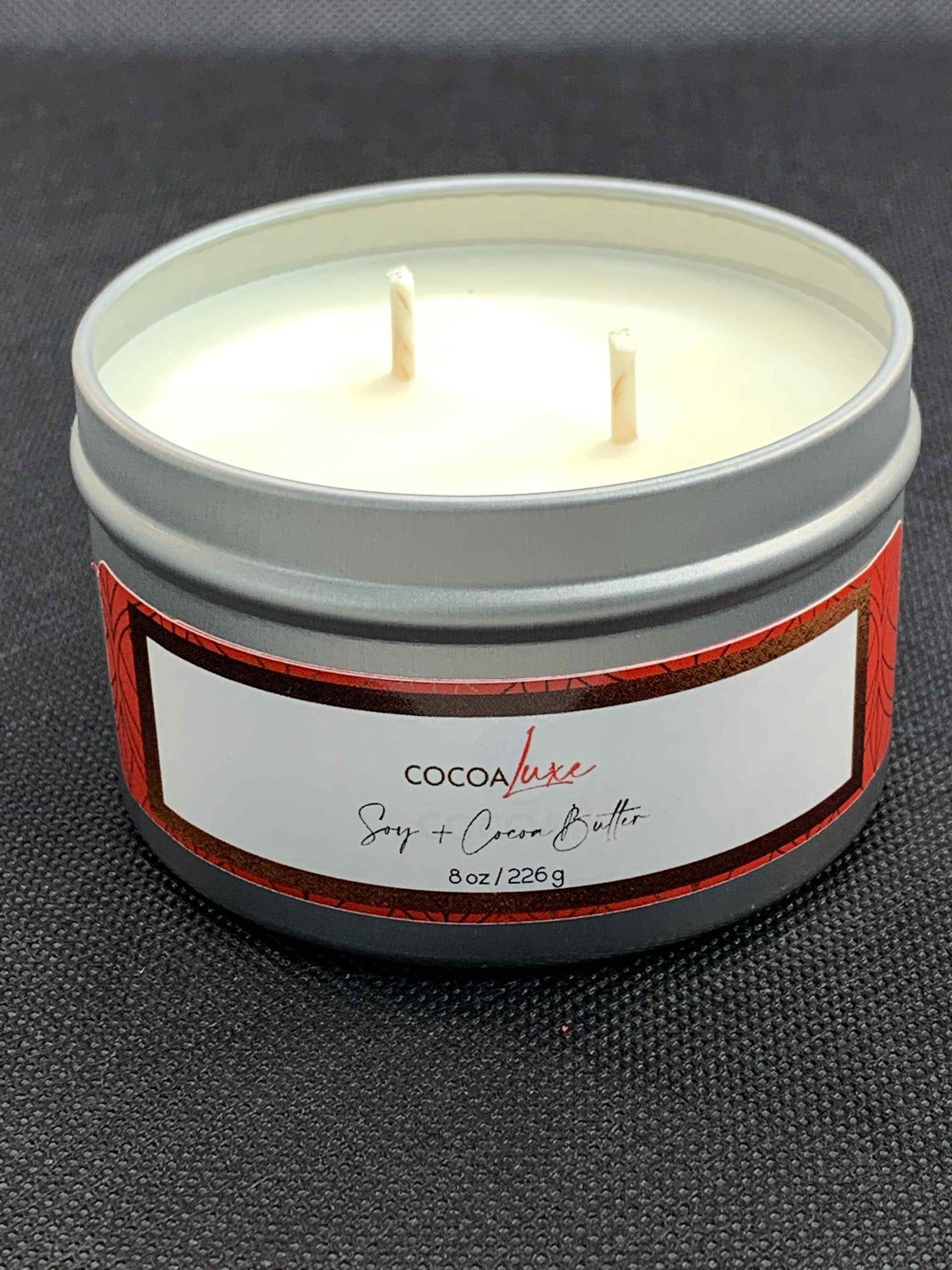 CocoaLuxe 8 oz soy and cocoa butter candle in silver tin with red and white label